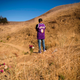 Anthony Calderon leaves flowers to pay his respects at a makeshift memorial on January 26, 2021, in Calabasas, California, at the hillside site of a helicopter crash a year ago that killed nine people, including Lakers basketball player Kobe Bryant and daughter Gianna Bryant.